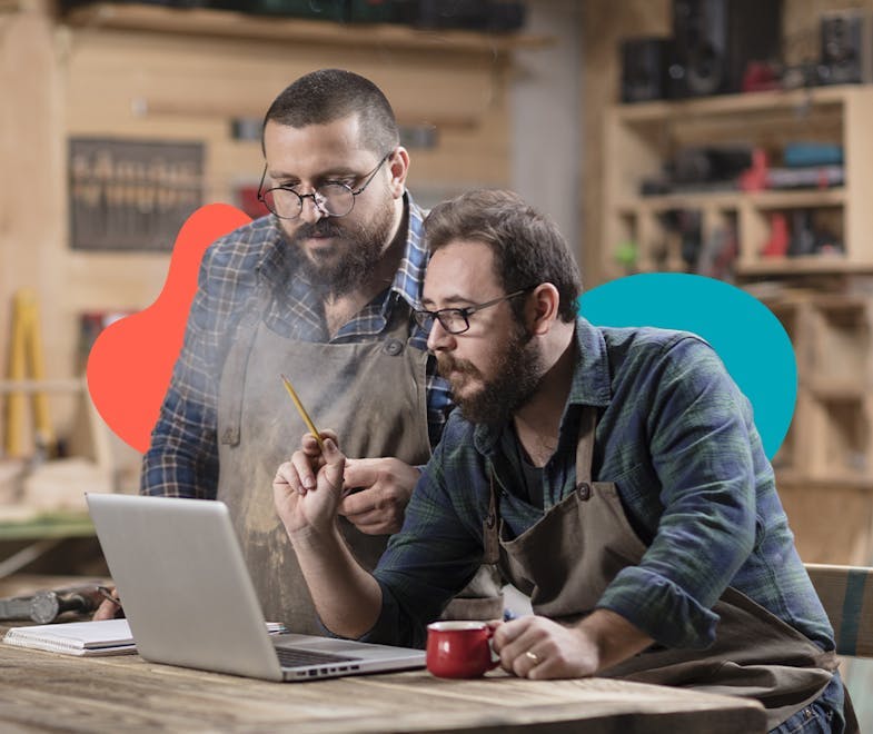 2 business mates looking at a computer to represent them looking up their tax responsibilities