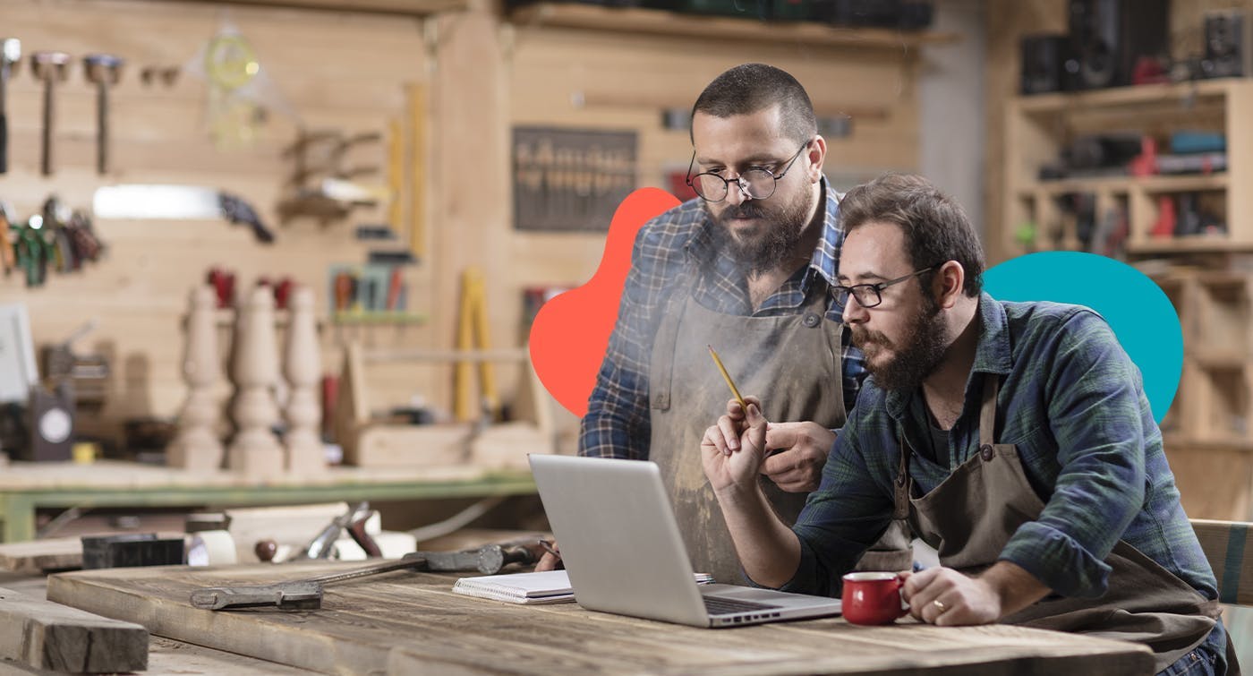 2 business mates looking at a computer to represent them looking up their tax responsibilities