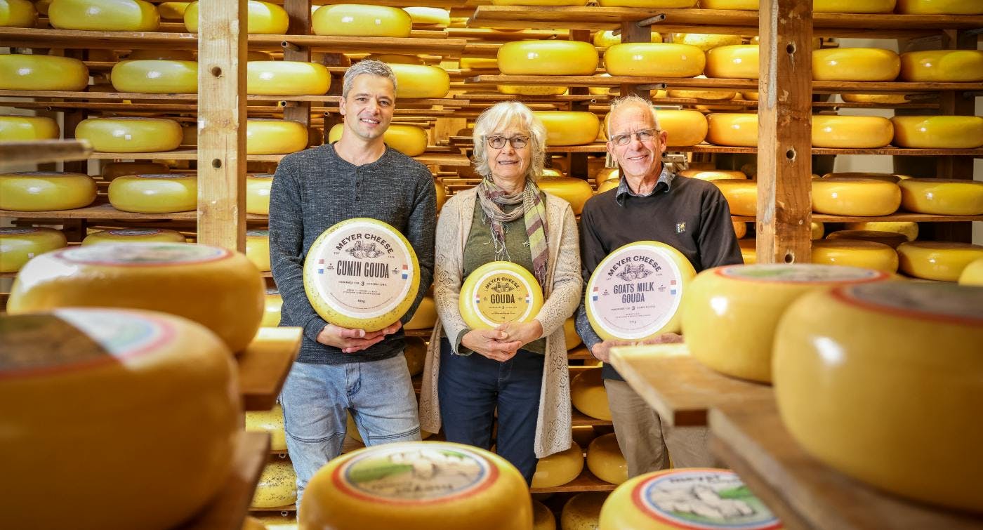 Meyer cheese - a few of the team holding some of the large rounds of cheese